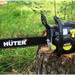 Hooter chainsaw on a stump in the forest