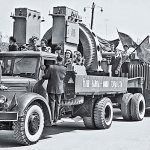 A copy of the MAZ-200P, No. 12-98 mdg, towing a T-151A trailer at a festive demonstration in Tiraspol. The road train decorated with banners and flags demonstrates the products of the Elektromash production and technical association. Moldavian SSR, May 1, 1964 