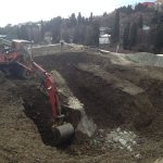 Digging a pit with an excavator